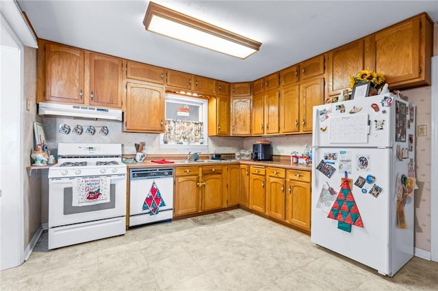 kitchen featuring white appliances and sink