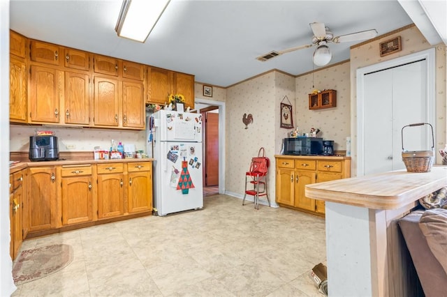 kitchen with white refrigerator and ceiling fan