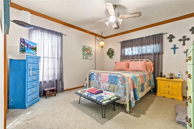 carpeted bedroom with ceiling fan and crown molding