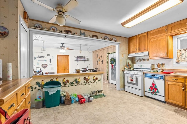 kitchen with ceiling fan, white appliances, and hanging light fixtures