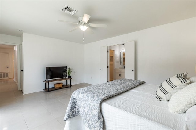 tiled bedroom with ensuite bathroom and ceiling fan