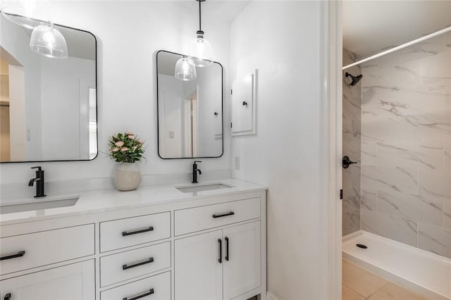 bathroom featuring a tile shower and vanity