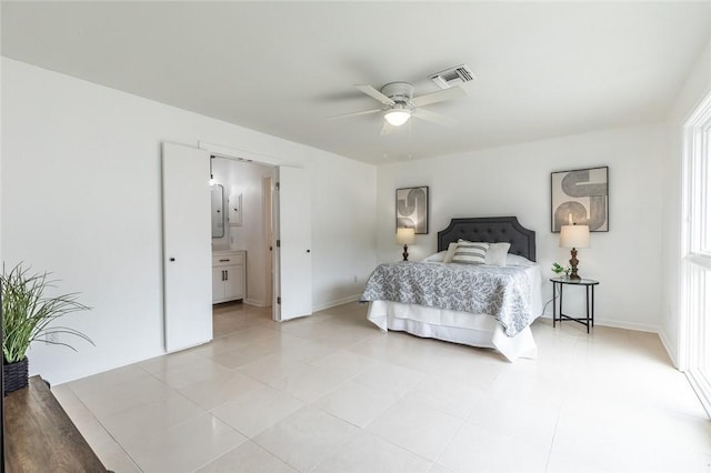 bedroom featuring ensuite bathroom, ceiling fan, and light tile patterned floors