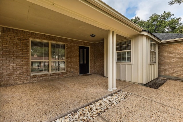 view of exterior entry featuring a patio