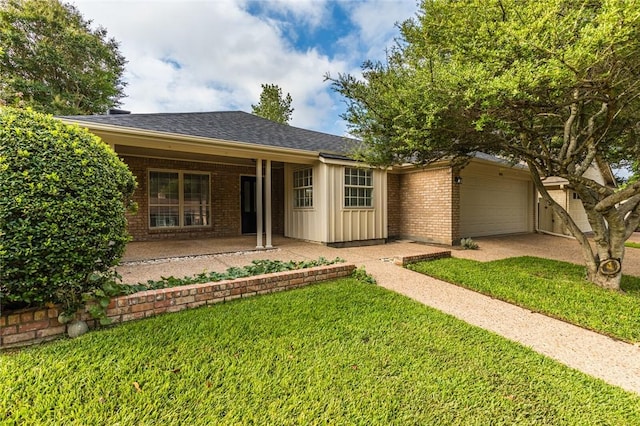 single story home featuring a front yard, a garage, and covered porch