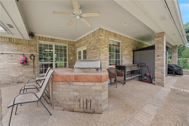 view of patio / terrace featuring grilling area, ceiling fan, and exterior kitchen