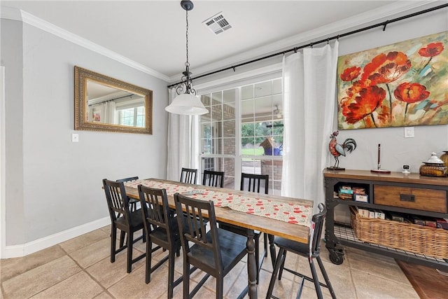 dining room with ornamental molding and light tile patterned flooring