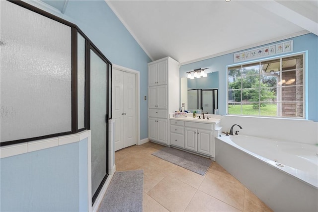 bathroom with tile patterned floors, vanity, independent shower and bath, and vaulted ceiling