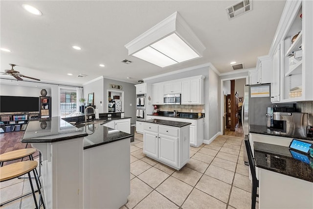 kitchen featuring white cabinetry, a large island, and appliances with stainless steel finishes