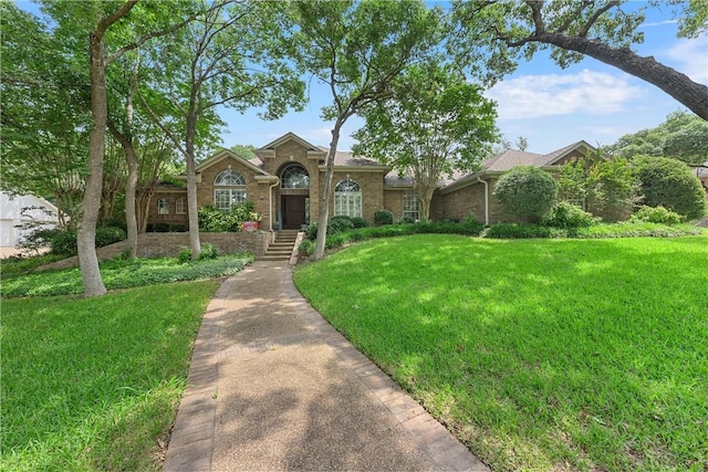 ranch-style home featuring a front lawn