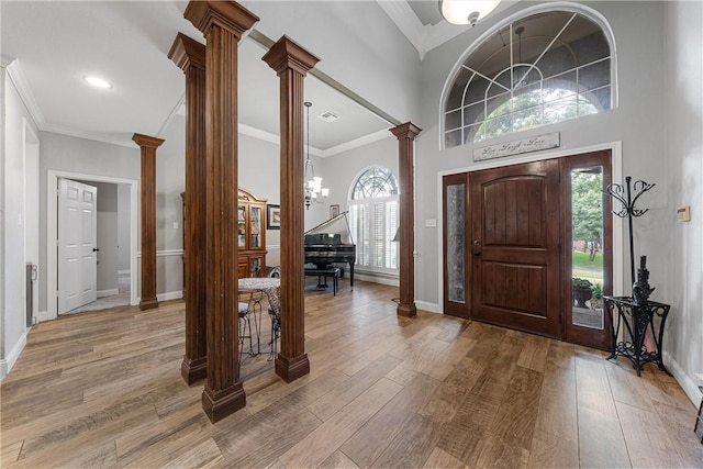 entryway featuring hardwood / wood-style flooring, ornate columns, and plenty of natural light