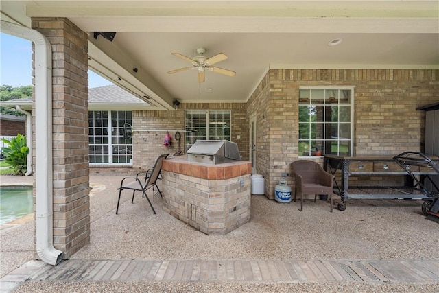 view of patio featuring grilling area, ceiling fan, and an outdoor kitchen