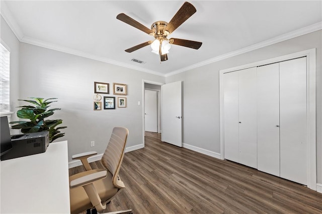 office space with a ceiling fan, baseboards, wood finished floors, visible vents, and ornamental molding