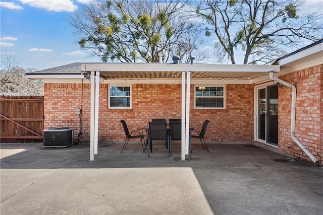 view of patio / terrace with outdoor dining space, cooling unit, and fence