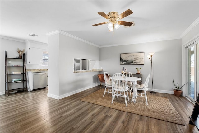 dining room featuring visible vents, plenty of natural light, and wood finished floors