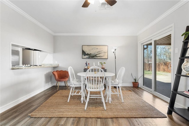 dining area with visible vents, crown molding, baseboards, and wood finished floors