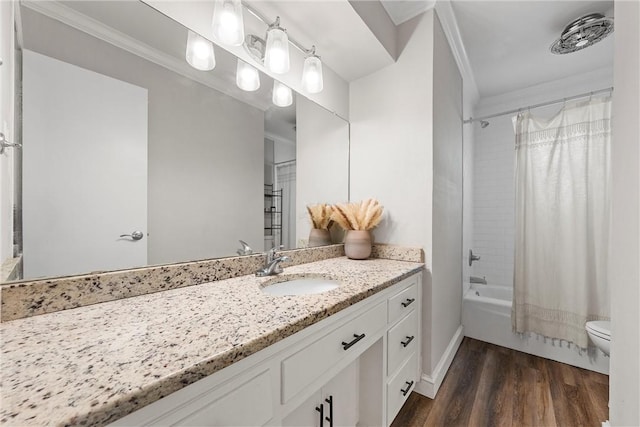 bathroom with vanity, toilet, wood finished floors, and ornamental molding