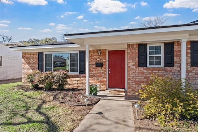 property entrance with brick siding