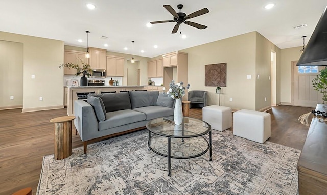 living room with hardwood / wood-style flooring and ceiling fan