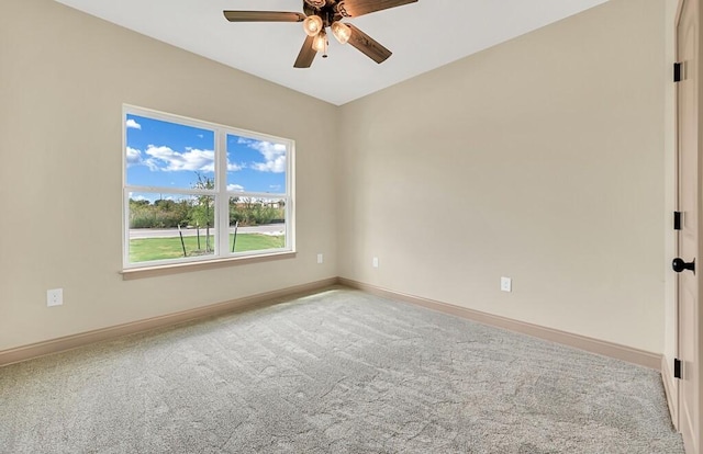 carpeted spare room with ceiling fan