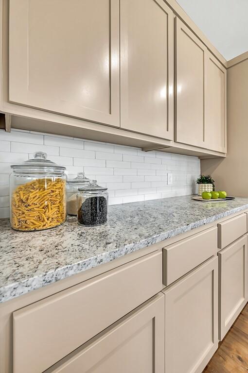 room details featuring decorative backsplash and wood-type flooring