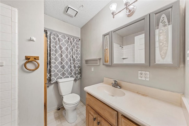 bathroom featuring vanity, a textured ceiling, and toilet