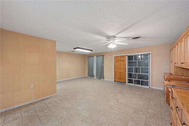 spare room with ceiling fan and a textured ceiling