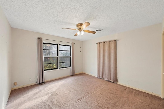 empty room featuring a textured ceiling, carpet floors, and ceiling fan