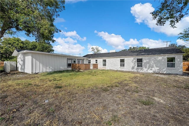 rear view of property featuring a yard