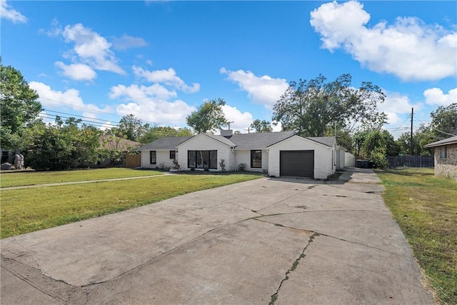 view of front of home with a garage and a front lawn