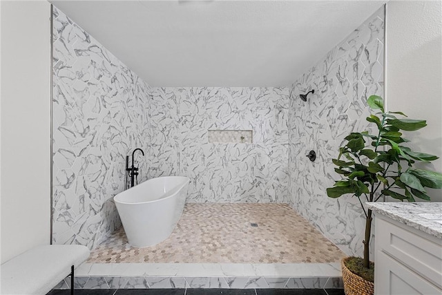 bathroom featuring tile patterned floors, vanity, walk in shower, and tile walls