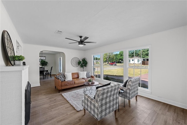 living room featuring hardwood / wood-style flooring and ceiling fan