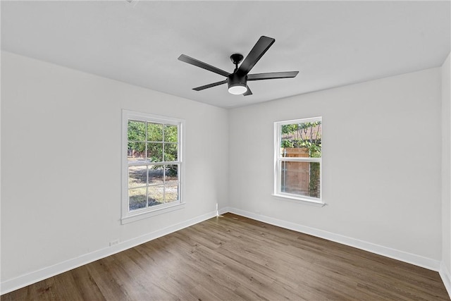 empty room with ceiling fan and hardwood / wood-style flooring