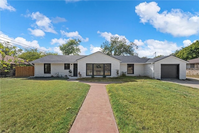 ranch-style home with a front yard and a garage