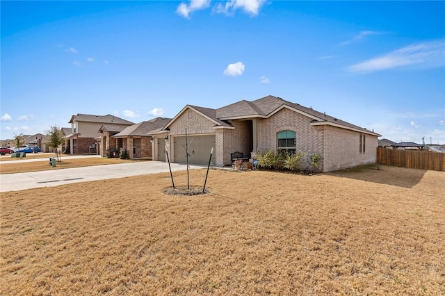 ranch-style home featuring a garage and a front yard