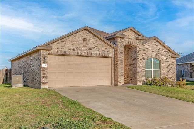 view of front of property featuring central AC, a front lawn, and a garage