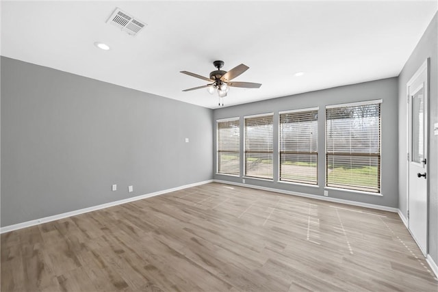 empty room with baseboards, visible vents, light wood-style flooring, recessed lighting, and ceiling fan