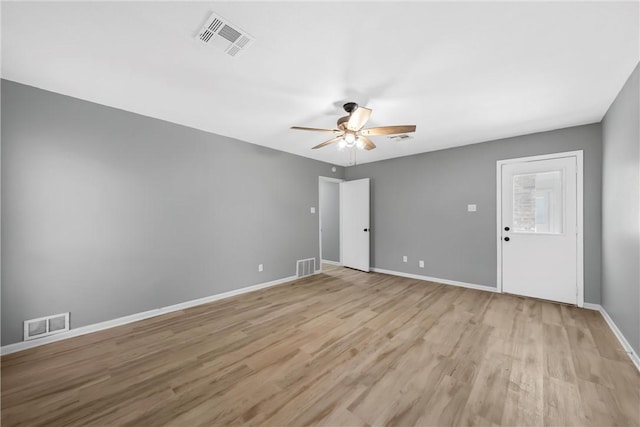 spare room featuring visible vents, light wood finished floors, and ceiling fan