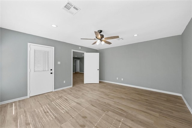 empty room featuring visible vents, baseboards, a ceiling fan, and light wood finished floors