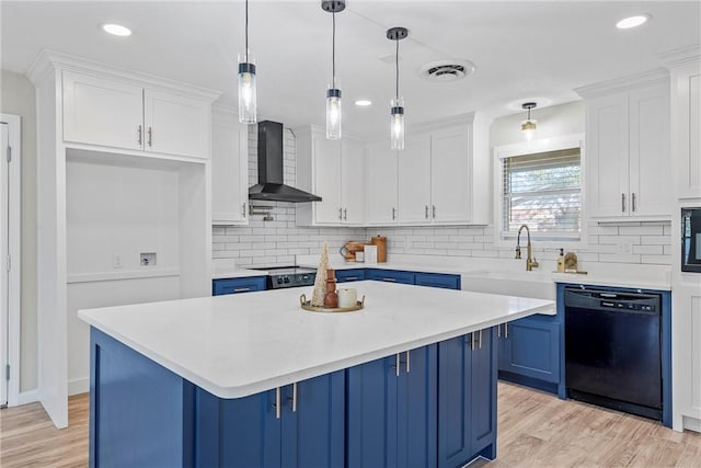 kitchen featuring wall chimney exhaust hood, blue cabinets, pendant lighting, white cabinets, and black dishwasher