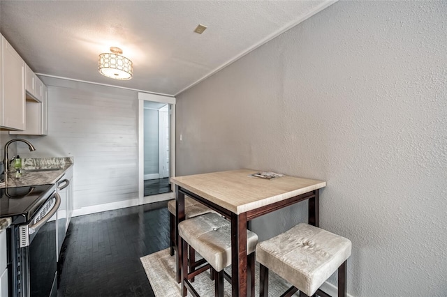 dining space featuring dark hardwood / wood-style flooring and sink