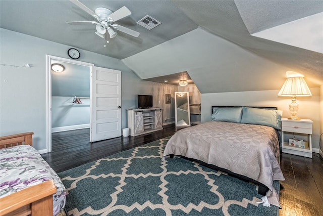 bedroom with vaulted ceiling, dark hardwood / wood-style floors, and ceiling fan