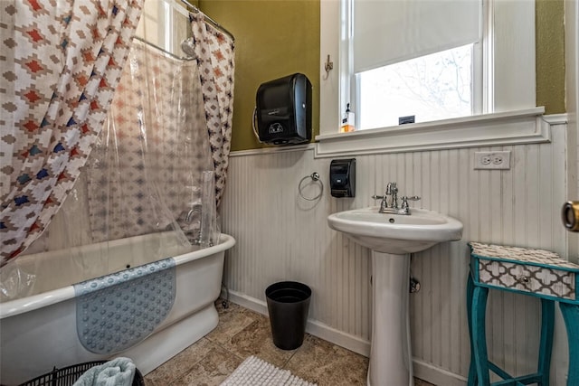 bathroom with a washtub and sink