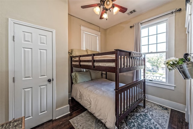 bedroom with dark hardwood / wood-style floors and ceiling fan