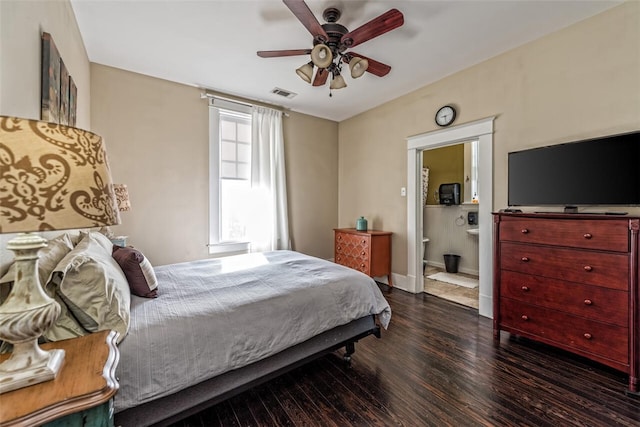 bedroom featuring dark wood-type flooring, ceiling fan, and ensuite bathroom