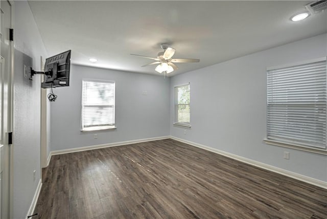 spare room with dark hardwood / wood-style floors and ceiling fan