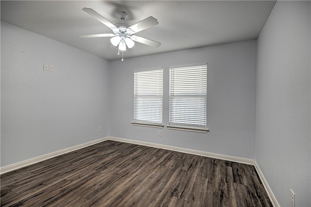 spare room featuring ceiling fan and dark wood-type flooring