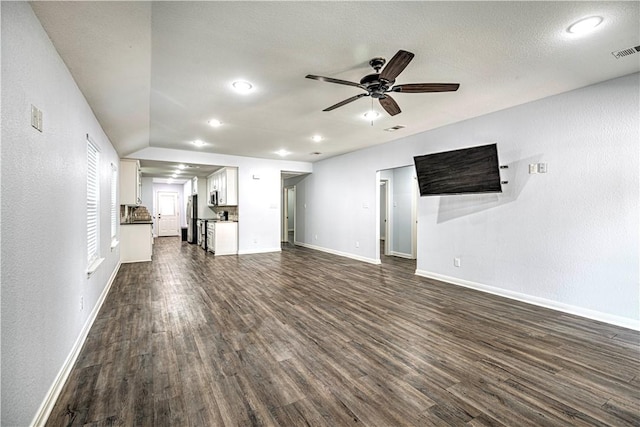 unfurnished living room with dark hardwood / wood-style floors and ceiling fan