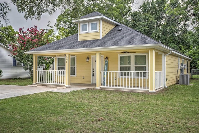 bungalow with central air condition unit, a front lawn, and a porch