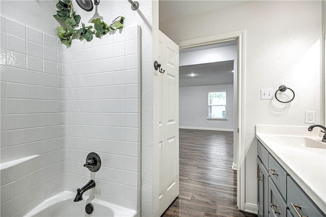 bathroom featuring vanity, wood-type flooring, a textured ceiling, and shower / tub combination